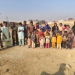 Families and children gathered at a brick kiln in Pakistan during Global Freedom Mission field work.
