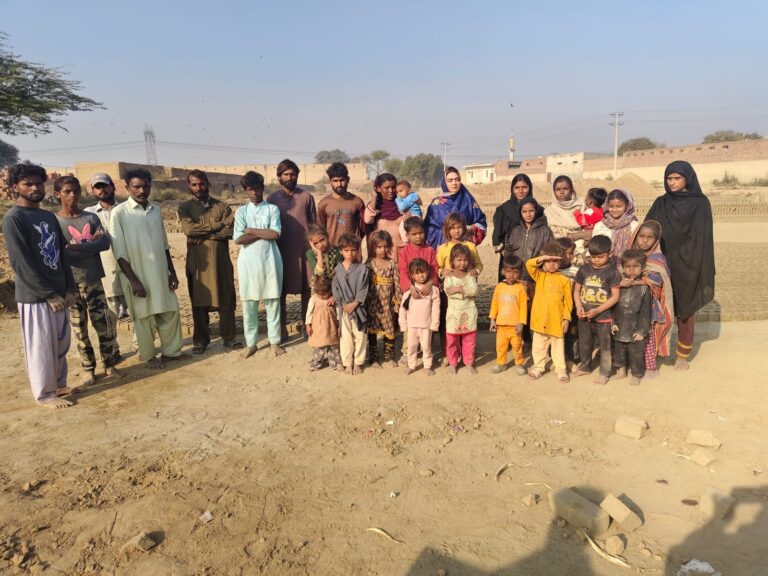Families and children gathered at a brick kiln in Pakistan during Global Freedom Mission field work.