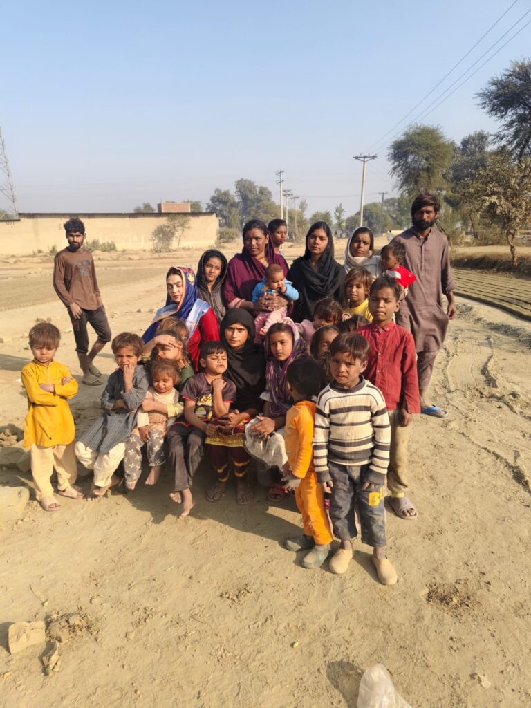 Young children gathered at a brick-kiln community in Pakistan.